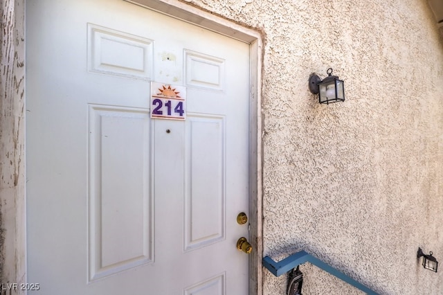 4960 Harrison Dr Unit 214, Las Vegas, NV 89120 - doorway to property with stucco siding