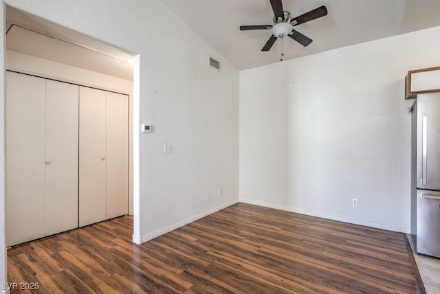 4960 Harrison Dr Unit 214, Las Vegas, NV 89120 - unfurnished bedroom with high quality fridge, wood finished floors, vaulted ceiling, baseboards, and a closet