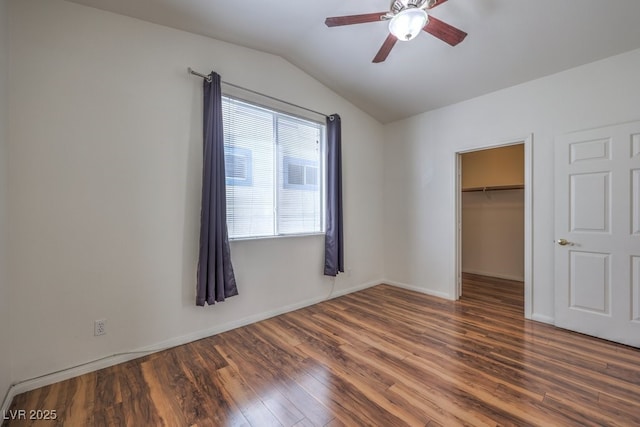 4960 Harrison Dr Unit 214, Las Vegas, NV 89120 - unfurnished bedroom with lofted ceiling, wood finished floors, a walk in closet, a closet, and baseboards