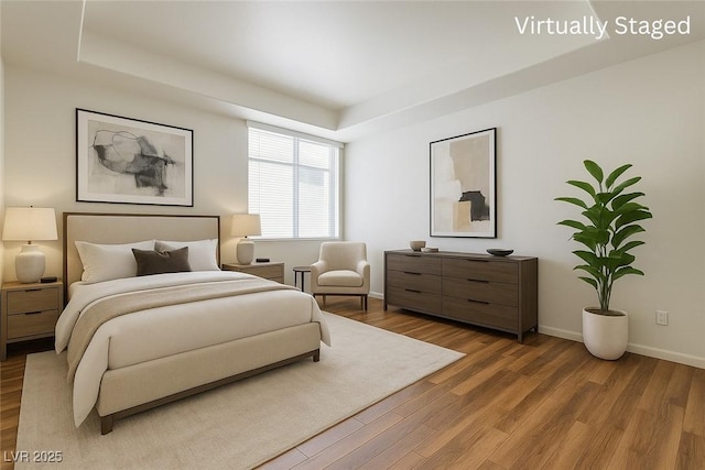 4960 Harrison Dr Unit 214, Las Vegas, NV 89120 - bedroom with wood finished floors, baseboards, and a raised ceiling