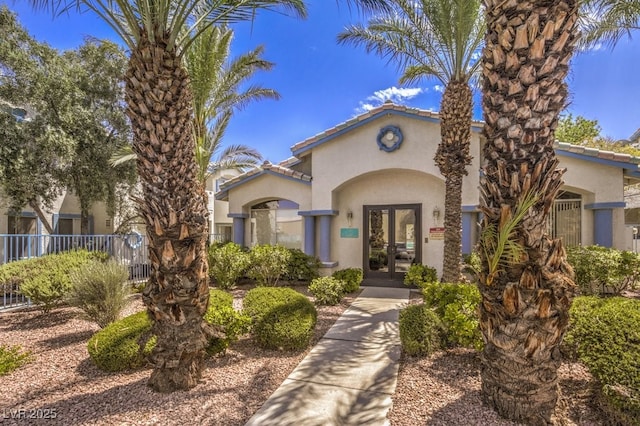 4960 Harrison Dr Unit 214, Las Vegas, NV 89120 - mediterranean / spanish house with french doors, stucco siding, and a tiled roof