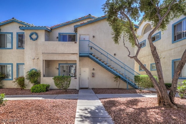 4960 Harrison Dr Unit 214, Las Vegas, NV 89120 - view of front of house featuring stucco siding and stairway
