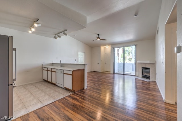 4960 Harrison Dr Unit 214, Las Vegas, NV 89120 - kitchen with dishwasher, open floor plan, a peninsula, a ceiling fan, and light wood-style flooring