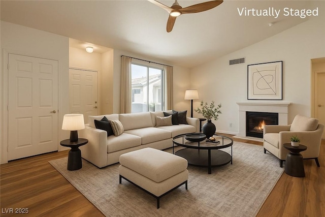 4960 Harrison Dr Unit 214, Las Vegas, NV 89120 - living room with vaulted ceiling, wood finished floors, ceiling fan, and a fireplace with flush hearth