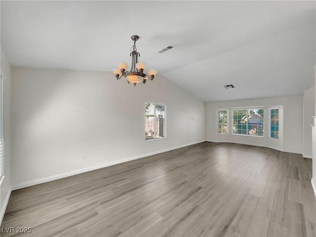 8632 Skyward Ct, Las Vegas, NV 89145 - spare room with a chandelier, wood finished floors, lofted ceiling, and baseboards