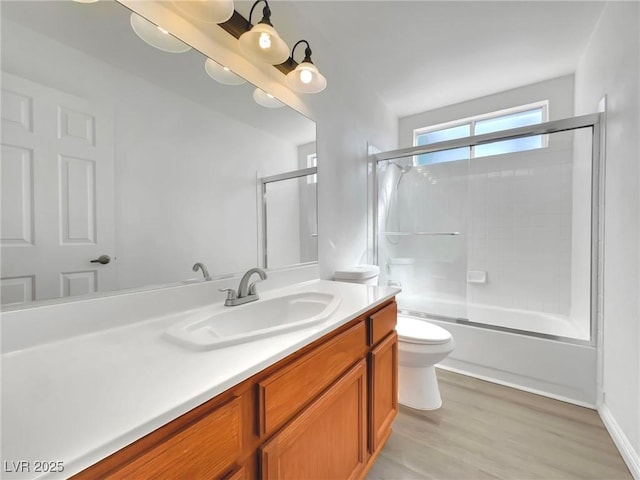 8632 Skyward Ct, Las Vegas, NV 89145 - bathroom with toilet, vanity, shower / bath combination with glass door, and wood finished floors