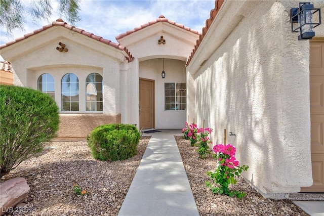 4176 Demoline Cir, Las Vegas, NV 89141 - view of exterior entry with stucco siding and a tiled roof