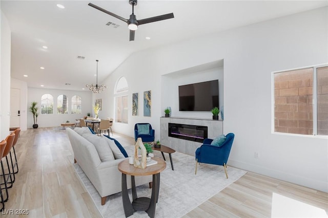4176 Demoline Cir, Las Vegas, NV 89141 - living area with a premium fireplace, ceiling fan, recessed lighting, light wood-style floors, and vaulted ceiling