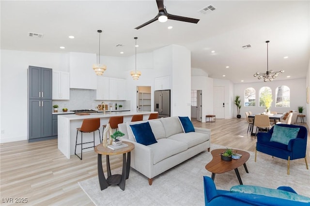 4176 Demoline Cir, Las Vegas, NV 89141 - living area with recessed lighting, light wood-type flooring, a chandelier, a ceiling fan, and lofted ceiling