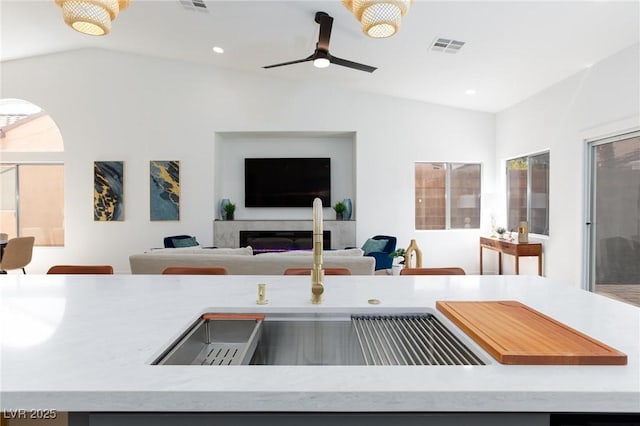 4176 Demoline Cir, Las Vegas, NV 89141 - kitchen with lofted ceiling, open floor plan, ceiling fan, light countertops, and recessed lighting