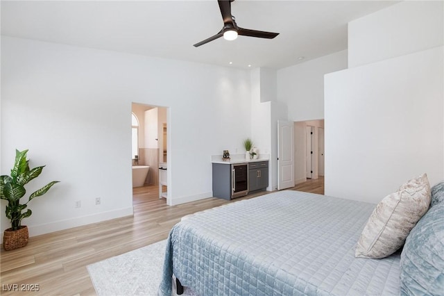 4176 Demoline Cir, Las Vegas, NV 89141 - bedroom featuring light wood finished floors, a towering ceiling, and connected bathroom