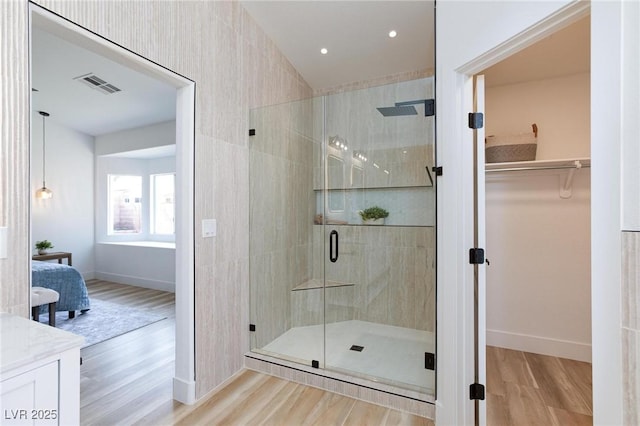4176 Demoline Cir, Las Vegas, NV 89141 - full bath with wood finished floors, a shower stall, a spacious closet, vanity, and ensuite bath