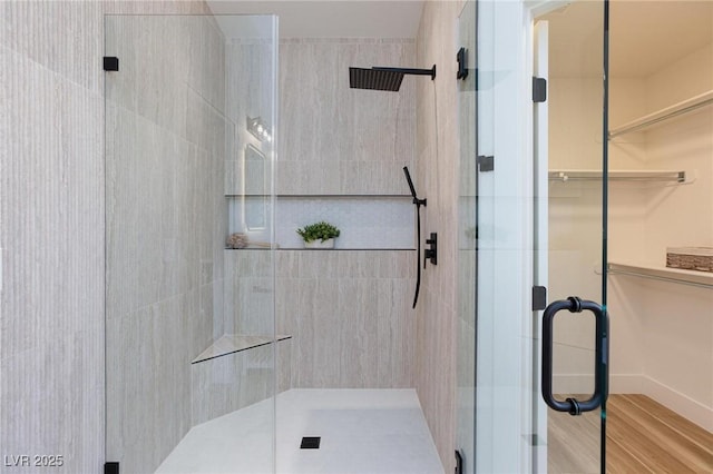 4176 Demoline Cir, Las Vegas, NV 89141 - bathroom with a shower stall, a spacious closet, and wood finished floors