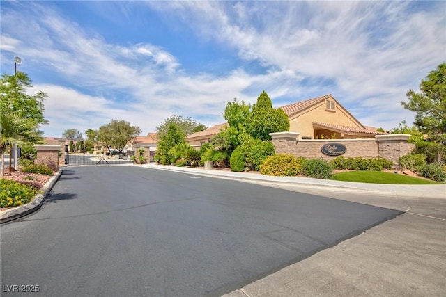 4176 Demoline Cir, Las Vegas, NV 89141 - view of asphalt road featuring a gate, a gated entry, and curbs