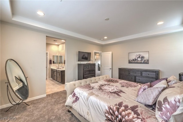 2711 Evolutionary Ln, Las Vegas, NV 89138 - bedroom with a raised ceiling, light colored carpet, recessed lighting, connected bathroom, and baseboards