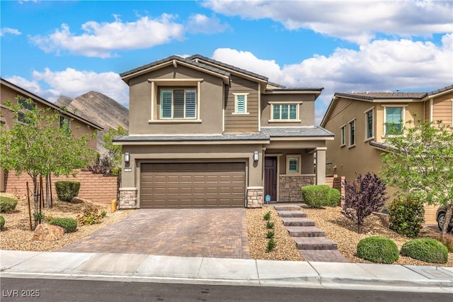 2711 Evolutionary Ln, Las Vegas, NV 89138 - view of front facade featuring stone siding, stucco siding, and an attached garage