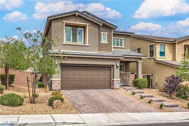 2711 Evolutionary Ln, Las Vegas, NV 89138 - view of front of property featuring stone siding, stucco siding, an attached garage, and decorative driveway