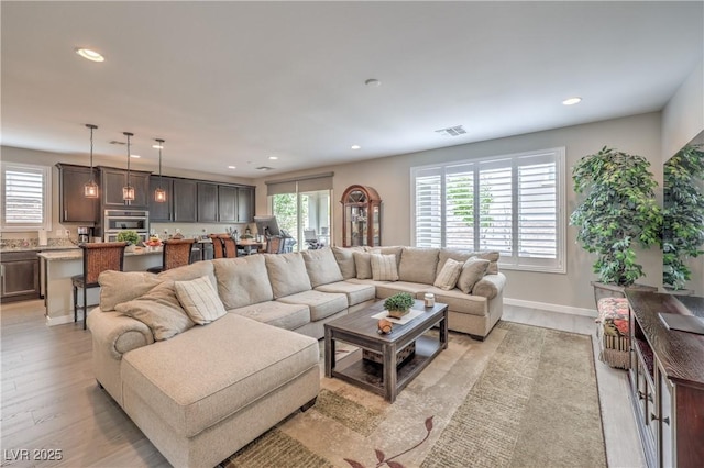 2711 Evolutionary Ln, Las Vegas, NV 89138 - living room featuring recessed lighting, healthy amount of natural light, light wood-style flooring, and baseboards