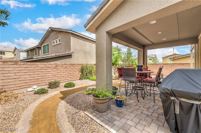 2711 Evolutionary Ln, Las Vegas, NV 89138 - fenced backyard featuring a patio, outdoor dining area, and a grill