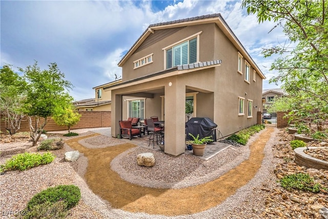2711 Evolutionary Ln, Las Vegas, NV 89138 - rear view of house featuring stucco siding, a patio, and a fenced backyard