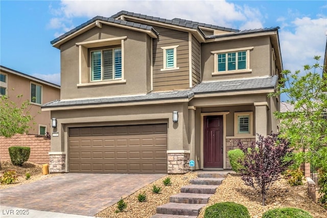 2711 Evolutionary Ln, Las Vegas, NV 89138 - view of front of home with stone siding, a garage, stucco siding, and decorative driveway