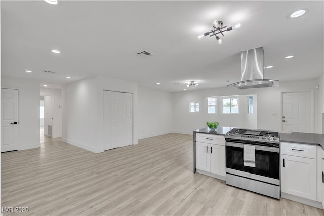 4404 Hillcrest Ave, Las Vegas, NV 89102 - kitchen featuring stainless steel gas stove, extractor fan, open floor plan, dark countertops, and recessed lighting