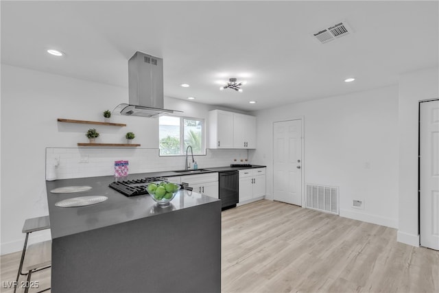 4404 Hillcrest Ave, Las Vegas, NV 89102 - kitchen featuring island exhaust hood, a sink, black appliances, dark countertops, and white cabinets