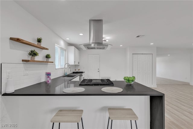 4404 Hillcrest Ave, Las Vegas, NV 89102 - kitchen featuring a sink, dark countertops, open shelves, decorative backsplash, and white cabinetry