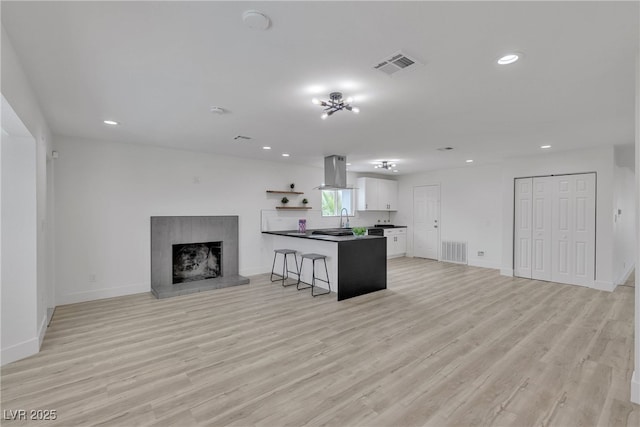4404 Hillcrest Ave, Las Vegas, NV 89102 - unfurnished living room featuring light wood-type flooring, recessed lighting, a sink, and baseboards