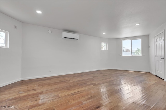 4404 Hillcrest Ave, Las Vegas, NV 89102 - basement with an AC wall unit, plenty of natural light, light wood finished floors, and recessed lighting