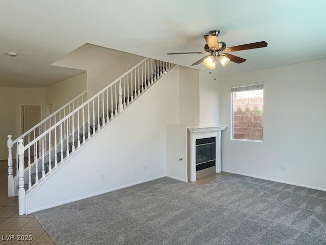 740 White Grotto St, Las Vegas, NV 89138 - unfurnished living room featuring ceiling fan, carpet flooring, stairs, and a fireplace