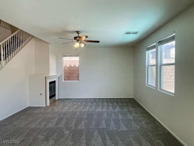 740 White Grotto St, Las Vegas, NV 89138 - unfurnished living room with plenty of natural light, carpet, a glass covered fireplace, and ceiling fan