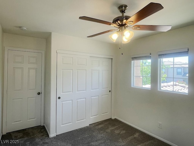 740 White Grotto St, Las Vegas, NV 89138 - unfurnished bedroom with dark colored carpet, a closet, baseboards, and a ceiling fan