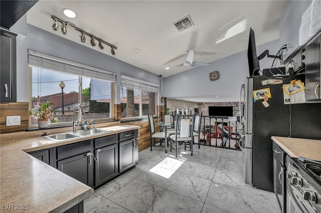 601 Cragin Park Dr, Las Vegas, NV 89107 - kitchen with a sink, stainless steel range with gas cooktop, a ceiling fan, light countertops, and backsplash