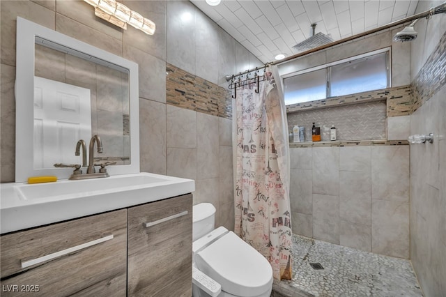 601 Cragin Park Dr, Las Vegas, NV 89107 - bathroom featuring tile walls, toilet, tiled shower, and vanity