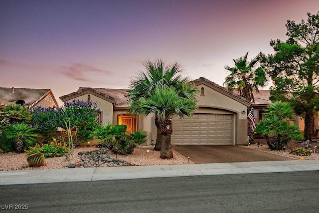 499 Eagle Vista Dr, Henderson, NV 89012 - view of front facade featuring a garage, driveway, stucco siding, and a tile roof