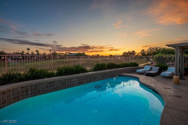 499 Eagle Vista Dr, Henderson, NV 89012 - pool at dusk with a fenced backyard and a patio