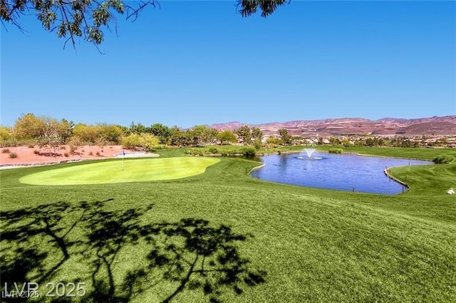 499 Eagle Vista Dr, Henderson, NV 89012 - view of property's community with a water and mountain view, a putting area, a yard, and view of golf course