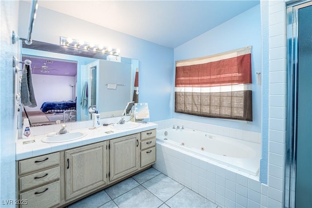 475 E Robindale Rd, Las Vegas, NV 89123 - bathroom with ensuite bathroom, a tub with jets, double vanity, tile patterned flooring, and vaulted ceiling