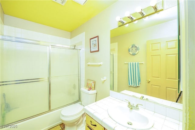 475 E Robindale Rd, Las Vegas, NV 89123 - bathroom with toilet, vanity, and shower / bath combination with glass door