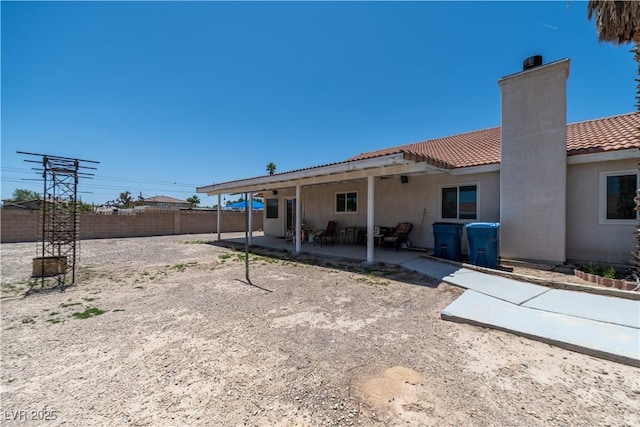 475 E Robindale Rd, Las Vegas, NV 89123 - back of house with a chimney, a tile roof, a patio, a fenced backyard, and stucco siding