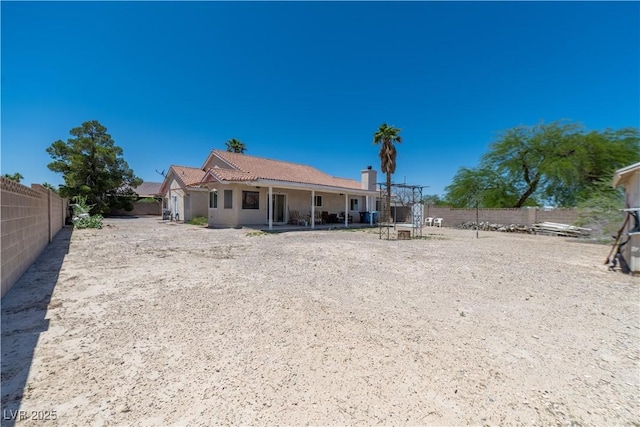 475 E Robindale Rd, Las Vegas, NV 89123 - rear view of house with a fenced backyard and stucco siding
