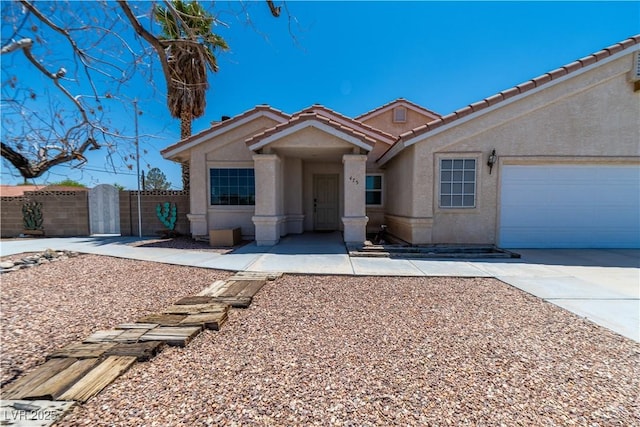 475 E Robindale Rd, Las Vegas, NV 89123 - single story home featuring stucco siding, a tile roof, driveway, and a garage