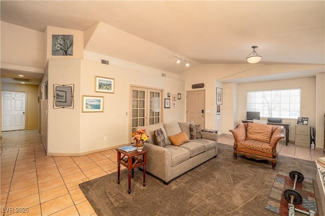 475 E Robindale Rd, Las Vegas, NV 89123 - living area with vaulted ceiling, light tile patterned floors, and baseboards