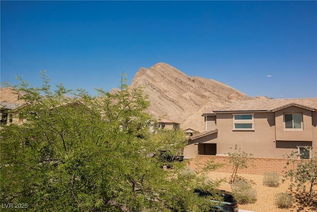 2750 Evolutionary Ln, Las Vegas, NV 89138 - view of side of property with stucco siding, a mountain view, and brick siding