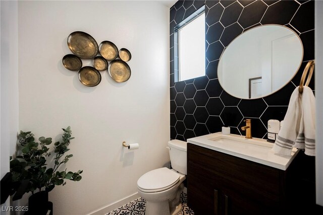 2750 Evolutionary Ln, Las Vegas, NV 89138 - bathroom with tile walls, vanity, toilet, decorative backsplash, and baseboards