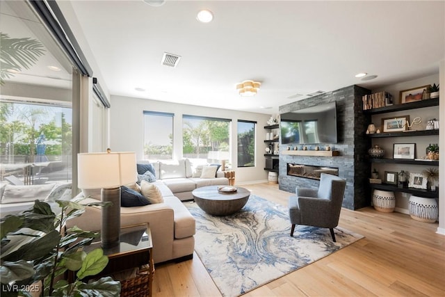 2750 Evolutionary Ln, Las Vegas, NV 89138 - living area featuring a stone fireplace, wood finished floors, and baseboards