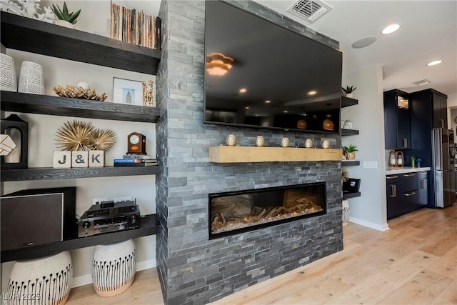 2750 Evolutionary Ln, Las Vegas, NV 89138 - living area with a stone fireplace, light wood-type flooring, baseboards, and recessed lighting