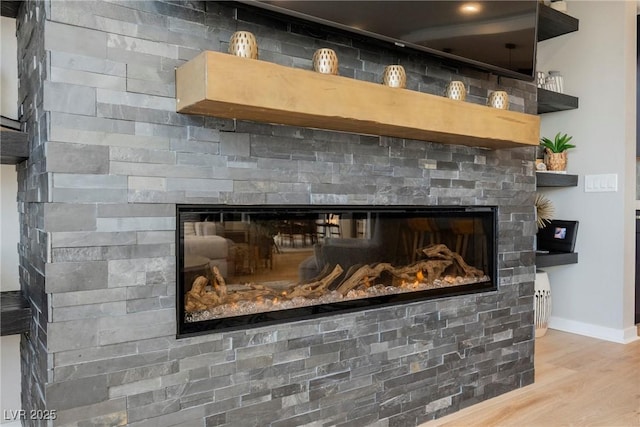 2750 Evolutionary Ln, Las Vegas, NV 89138 - detailed view of a glass covered fireplace, baseboards, and wood finished floors