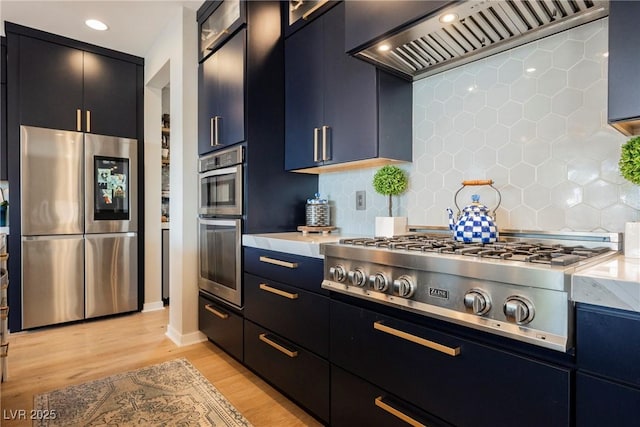 2750 Evolutionary Ln, Las Vegas, NV 89138 - kitchen with appliances with stainless steel finishes, premium range hood, dark cabinetry, light countertops, and recessed lighting